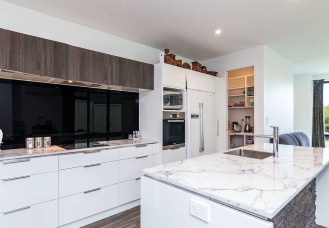 Modern kitchen renovation with marble benchtop by Deluxe Homes.