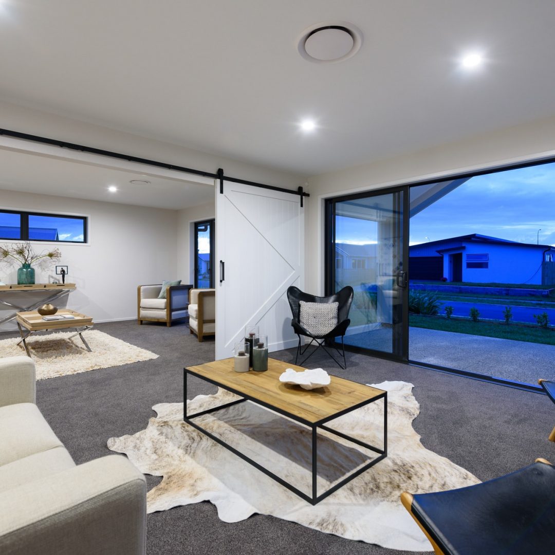 Open plan modern living area design by Deluxe Homes.