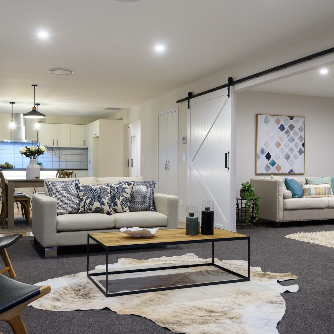 Open plan new build kitchen & living area with barn door features, by Deluxe Homes.
