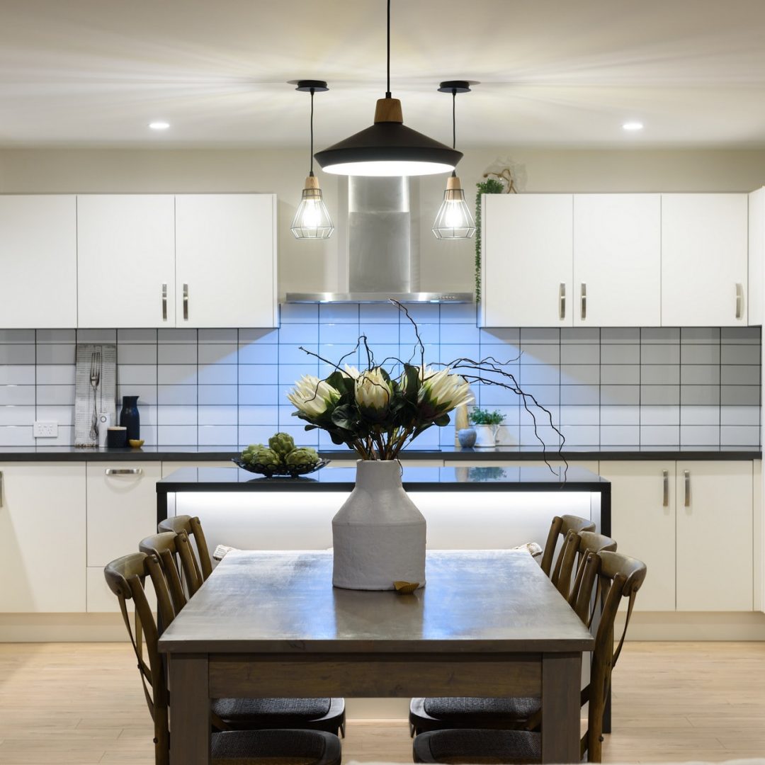 New open plan kitchen & modern lighting by Deluxe Homes.