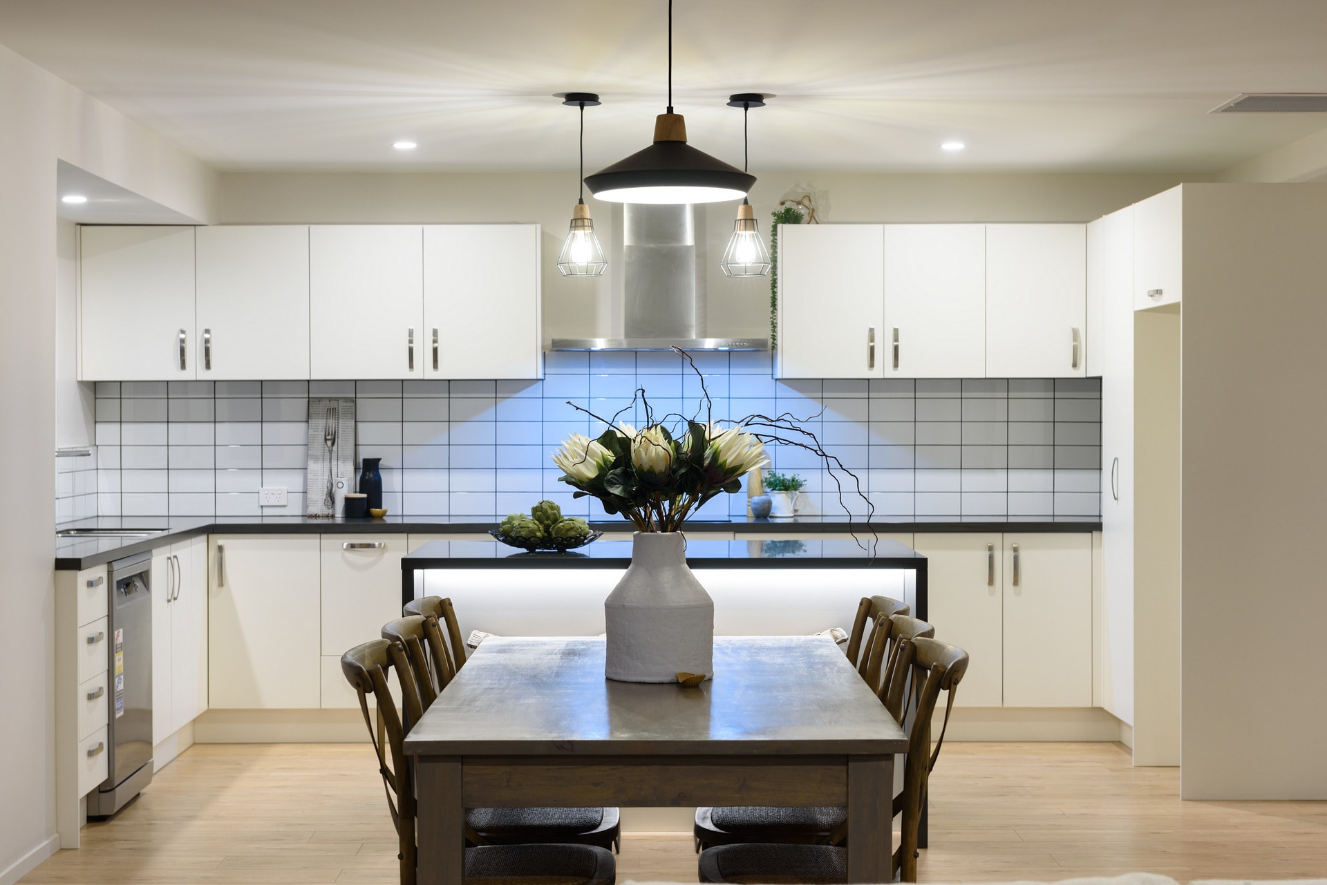 New open plan kitchen & modern lighting by Deluxe Homes.