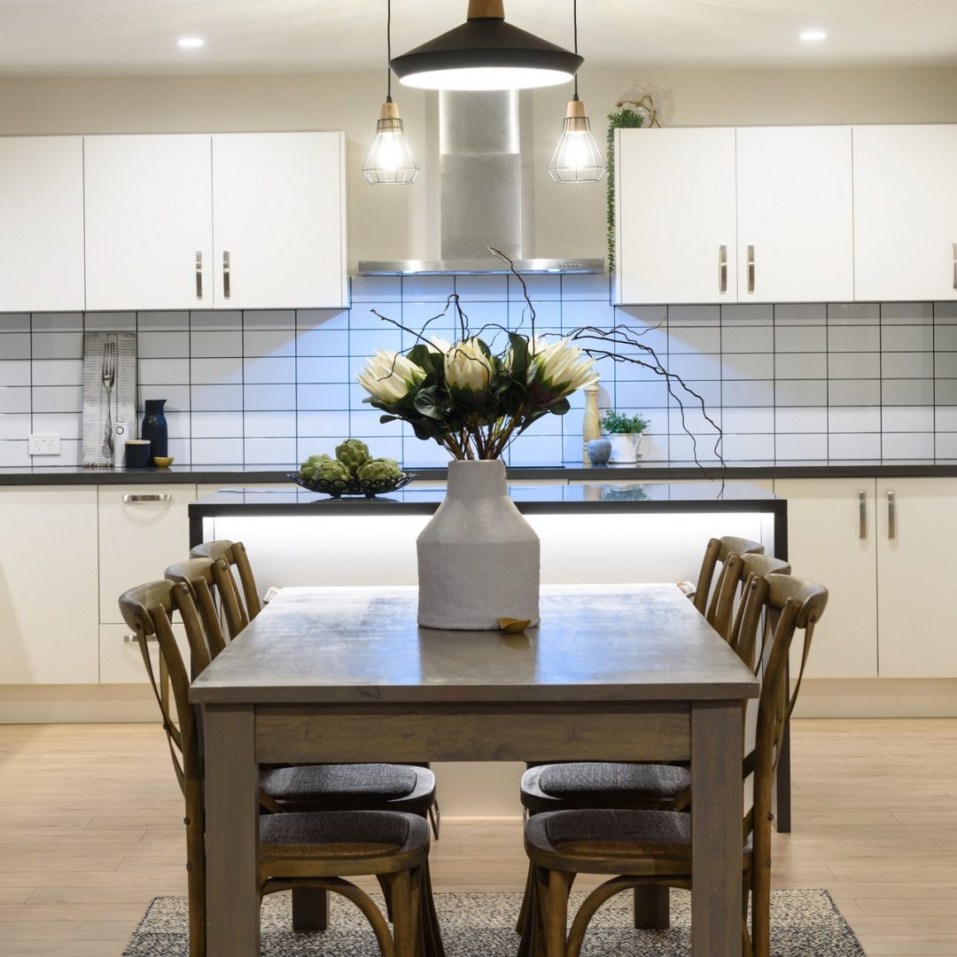 New home with open plan kitchen & subway tiles built by Deluxe Homes.