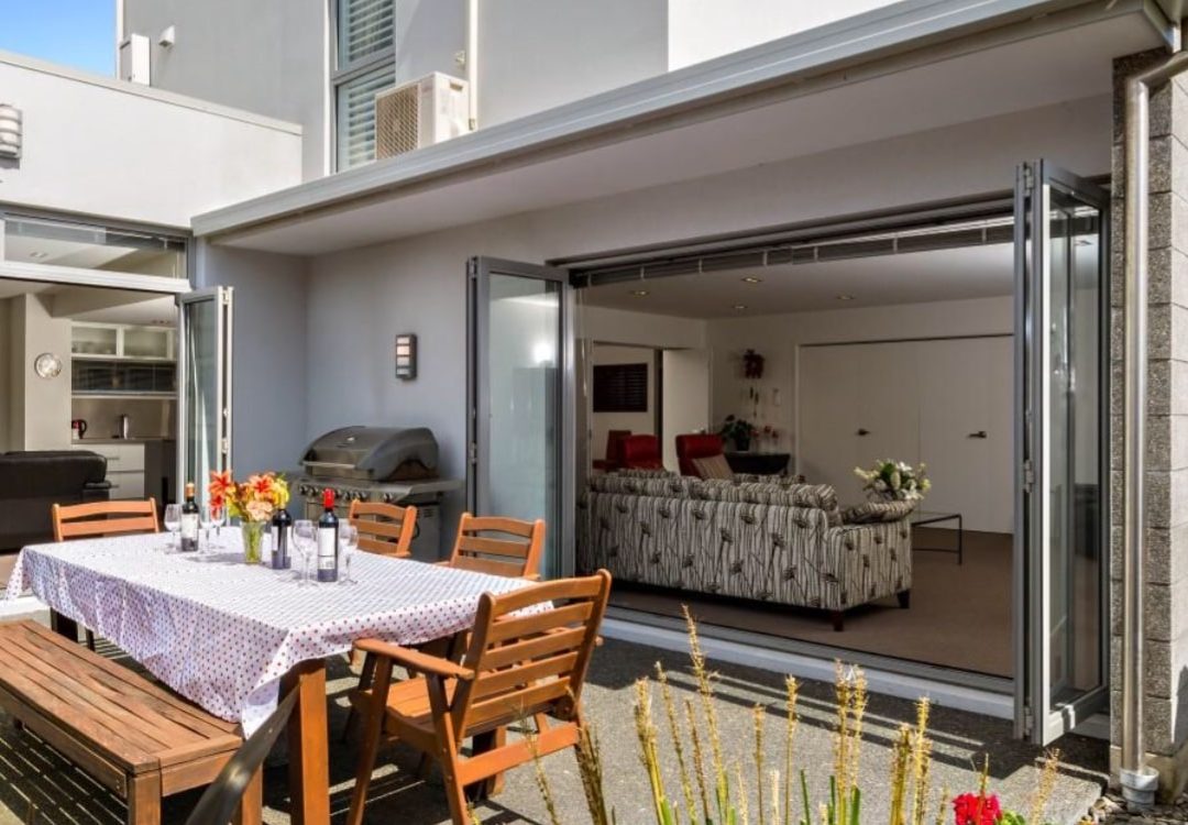 New modern apartment with outdoor flow built by Deluxe Homes.